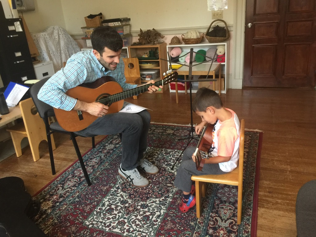 Providence Guitar Academy owner and director Phil Mazza teaching one of his young guitar students.